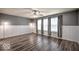Spacious bedroom with new flooring, bright windows with curtains, and wainscotting at 7657 Wheatgrass Ln, Noblesville, IN 46062