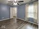 This well-lit bedroom with stylish grey flooring is spacious and includes a walk-in closet and large windows at 7657 Wheatgrass Ln, Noblesville, IN 46062