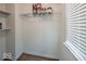 A storage closet with wood-look vinyl flooring and wire shelving holding assorted paints in this well-kept home at 7657 Wheatgrass Ln, Noblesville, IN 46062