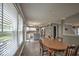 Open-concept dining area with wood table, bright windows, and kitchen access at 7657 Wheatgrass Ln, Noblesville, IN 46062