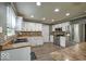Spacious kitchen featuring white cabinets, stainless steel appliances, and a functional island at 7657 Wheatgrass Ln, Noblesville, IN 46062