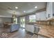 Bright kitchen boasts stainless steel appliances, a central island, and a view to the backyard at 7657 Wheatgrass Ln, Noblesville, IN 46062
