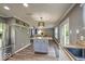 Open-concept kitchen with an island, stainless steel appliances, and lots of natural light at 7657 Wheatgrass Ln, Noblesville, IN 46062