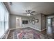 Comfortable living room with a ceiling fan, wall mounted TV and a view to the outside at 7657 Wheatgrass Ln, Noblesville, IN 46062