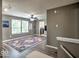 Cozy living room with modern flooring, ceiling fan, and decorative rug near bright windows at 7657 Wheatgrass Ln, Noblesville, IN 46062