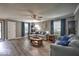 Bright living room with hardwood floors, ceiling fan, and ample natural light at 7657 Wheatgrass Ln, Noblesville, IN 46062