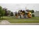Community playground with climbing structure and slides, surrounded by green space, perfect for recreation at 7657 Wheatgrass Ln, Noblesville, IN 46062