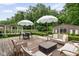 Inviting backyard features lounge furniture, dining table, shade umbrellas and a small cabana at 8436 N Meridian St, Indianapolis, IN 46260