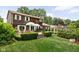Expansive backyard featuring a deck, lounge chairs, and neatly manicured landscaping with mature trees at 8436 N Meridian St, Indianapolis, IN 46260