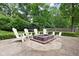 Cozy backyard fire pit area with Adirondack chairs, perfect for evening gatherings and relaxation at 8436 N Meridian St, Indianapolis, IN 46260