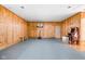 The basement includes wood paneling, a basketball hoop, a mini-arcade and a padded floor at 8436 N Meridian St, Indianapolis, IN 46260