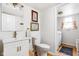 Bright bathroom features a vanity with modern fixtures and a separate laundry area for convenience at 8436 N Meridian St, Indianapolis, IN 46260