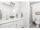 Bright bathroom featuring double sinks, white cabinets, and a shower with a stylish curtain at 8436 N Meridian St, Indianapolis, IN 46260