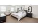Serene bedroom boasts neutral tones, large windows, and coordinated furnishings for a tranquil retreat at 8436 N Meridian St, Indianapolis, IN 46260