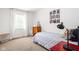 Cozy bedroom with twin bed, neutral walls, carpet floors, and a window for natural light at 8436 N Meridian St, Indianapolis, IN 46260