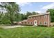 Charming brick two-story home with a manicured lawn and an inviting entrance at 8436 N Meridian St, Indianapolis, IN 46260