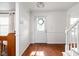 Bright foyer featuring hardwood floors, white trim, and staircase at 8436 N Meridian St, Indianapolis, IN 46260