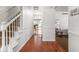 Bright hallway with hardwood floors, white trim, and staircase at 8436 N Meridian St, Indianapolis, IN 46260