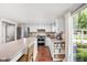 The kitchen provides an inviting space with stainless appliances, white cabinets and a lovely outdoor view at 8436 N Meridian St, Indianapolis, IN 46260