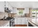 This kitchen features stainless steel appliances, ample counter space, tile backsplash, and a sliding door at 8436 N Meridian St, Indianapolis, IN 46260