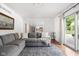 Bright living room provides an inviting space with a gray sofa, rug, and connection to a kitchen at 8436 N Meridian St, Indianapolis, IN 46260