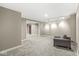 Basement with carpet flooring, featuring gray walls, a light and a gray arm chair at 8712 Admirals Bay Dr, Indianapolis, IN 46236
