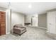 Basement featuring carpet flooring, gray walls, a light, brown arm chair, and multiple doors at 8712 Admirals Bay Dr, Indianapolis, IN 46236
