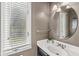 Stylish bathroom featuring a round mirror and a vanity with a white countertop at 8712 Admirals Bay Dr, Indianapolis, IN 46236