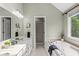 Relaxing bathroom with a soaking tub, double vanity, and abundant natural light at 8712 Admirals Bay Dr, Indianapolis, IN 46236