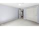 Bedroom with soft blue walls and carpet flooring, showcasing closet with sliding doors at 8712 Admirals Bay Dr, Indianapolis, IN 46236