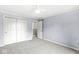 Spacious carpeted bedroom with soft blue walls, closet with sliding doors, and a ceiling fan at 8712 Admirals Bay Dr, Indianapolis, IN 46236