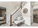 Charming foyer with stairs, decorative mirror, accent pillows, and paneled walls offering an inviting entrance at 8712 Admirals Bay Dr, Indianapolis, IN 46236