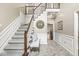 Elegant foyer showcasing the staircase, decorative mirror, and wainscoting that adds to the home's charm at 8712 Admirals Bay Dr, Indianapolis, IN 46236