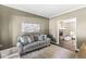 Cozy living room with a gray sofa, neutral decor, and a view of the fireplace in the next room at 8712 Admirals Bay Dr, Indianapolis, IN 46236