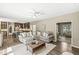 Open-concept living room with a comfortable gray sofa adjacent to the kitchen and dining area at 8712 Admirals Bay Dr, Indianapolis, IN 46236