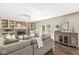 Spacious living room with a fireplace, built-in shelving, and access to the backyard at 8712 Admirals Bay Dr, Indianapolis, IN 46236