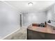 Basement office with neutral paint and carpet, track lighting, and a large corner desk at 8712 Admirals Bay Dr, Indianapolis, IN 46236