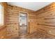 Inviting room with wood paneled walls, hardwood floors and a view into the kitchen at 89 S Grant St, Martinsville, IN 46151