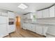 This kitchen features white cabinets, countertops, and stainless appliances at 89 S Grant St, Martinsville, IN 46151