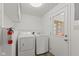 Bright laundry room featuring a washer, dryer, storage, and a door leading to the exterior at 89 S Grant St, Martinsville, IN 46151