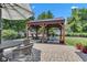 Beautiful backyard setting showcasing a gazebo, patio, and manicured landscaping, ideal for outdoor living at 900 W Busby St, Lebanon, IN 46052
