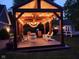 Charming backyard patio with a wooden pergola, string lights, and a variety of chairs, creating a welcoming outdoor retreat at 900 W Busby St, Lebanon, IN 46052