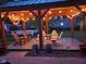 Inviting backyard patio features a wooden pergola with string lights and comfortable seating, creating an ideal outdoor space at 900 W Busby St, Lebanon, IN 46052