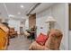 Basement recreational room featuring exposed ductwork, brick, and comfortable seating at 900 W Busby St, Lebanon, IN 46052