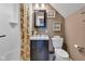 Well-lit bathroom features a vanity, toilet, and shower with a floral curtain at 900 W Busby St, Lebanon, IN 46052