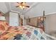 Comfortable bedroom featuring a patterned quilt, white trim, and access to another room at 900 W Busby St, Lebanon, IN 46052