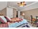 Relaxing bedroom featuring a quilt patterned bed, white trim, carpet, and desk at 900 W Busby St, Lebanon, IN 46052
