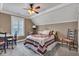 Cozy bedroom with a ceiling fan, white trim, a desk with chairs and comfortable bed at 900 W Busby St, Lebanon, IN 46052