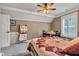 Inviting bedroom with ceiling fan, desk area, carpet flooring, and a window with shutters at 900 W Busby St, Lebanon, IN 46052