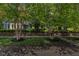Landscaped front yard with mature birch trees complimenting this home's exterior at 900 W Busby St, Lebanon, IN 46052